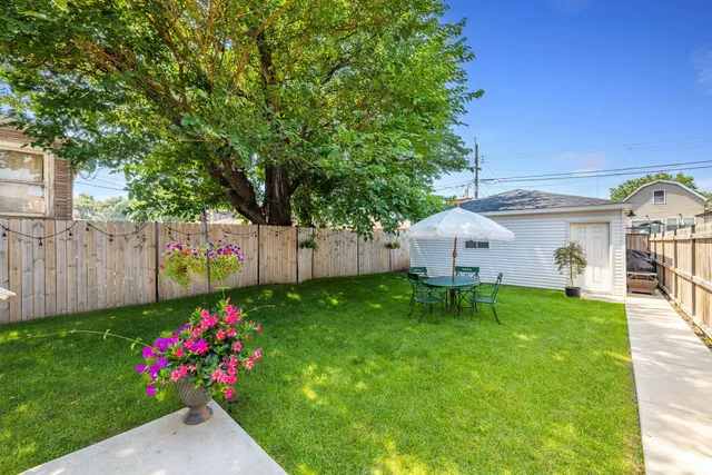 a view of a house with a yard and garden