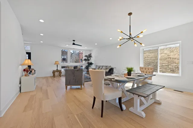 a living room with dining room and wooden floor