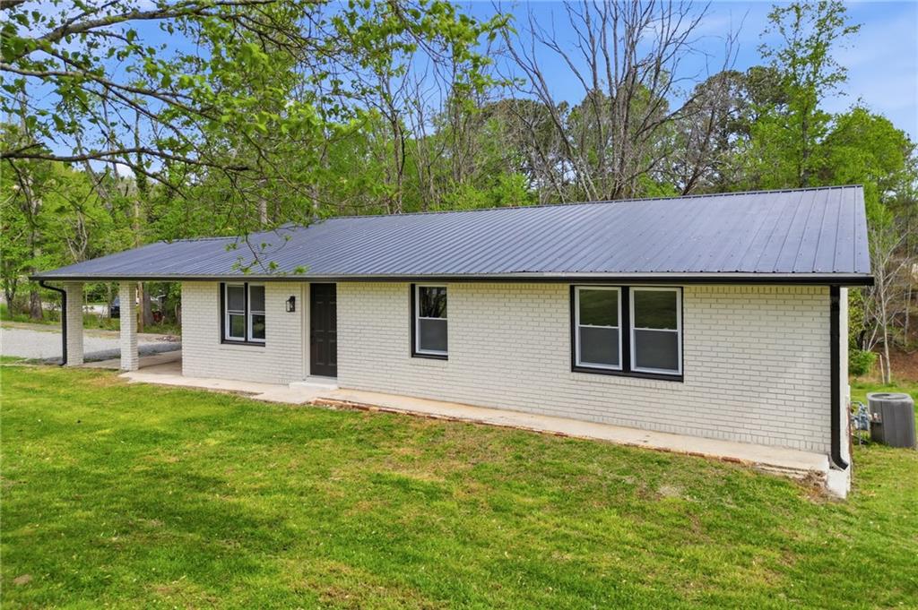 3011 Refuge Road Jasper, GA 30143 - Photo 1 of 1 a front view of a house with a garden