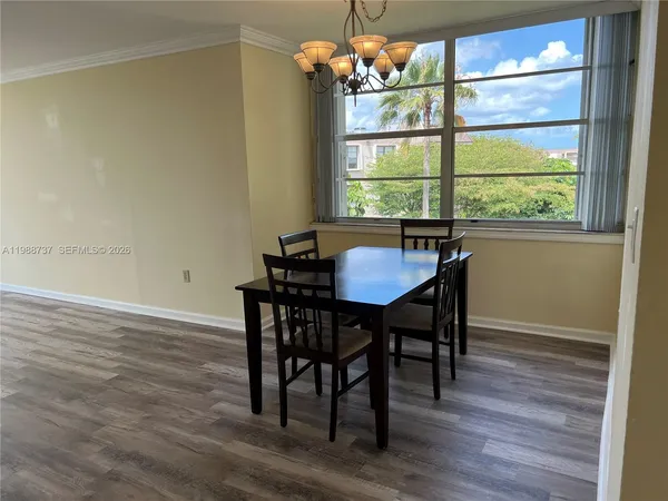 a dining room with furniture and window