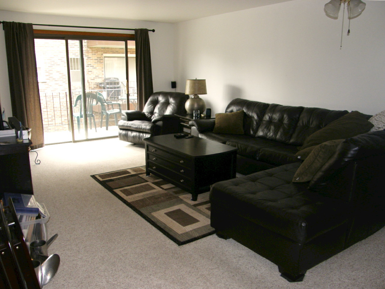 24 North Pistakee Lake Road, Unit 2D Fox Lake, IL 60020 - Photo 19 of 30 a living room with furniture and a floor to ceiling window