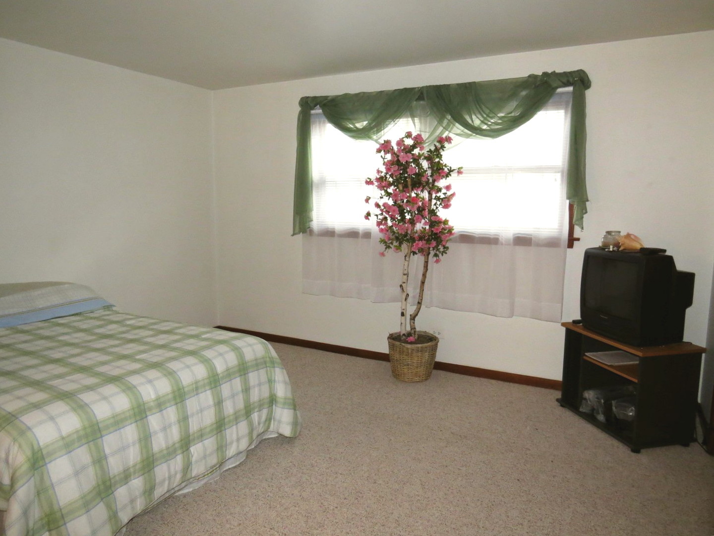 24 North Pistakee Lake Road, Unit 2D Fox Lake, IL 60020 - Photo 22 of 30 a bedroom with a bed and a window