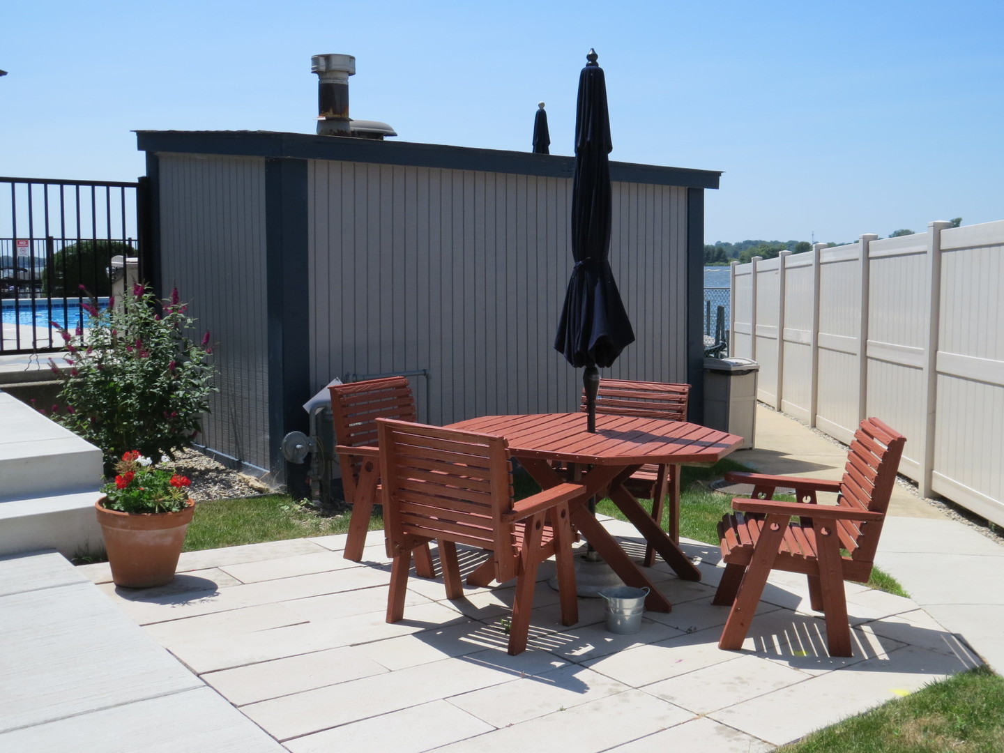 24 North Pistakee Lake Road, Unit 2D Fox Lake, IL 60020 - Photo 7 of 30 a backyard of a house with table and chairs