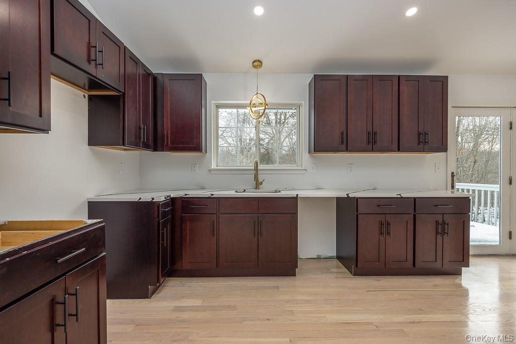 600 Twin Arch Road Rock Tavern, NY 12575 - Photo 11 of 25 Kitchen with light wood finished floors, hanging light fixtures, recessed lighting, light countertops, and a chandelier