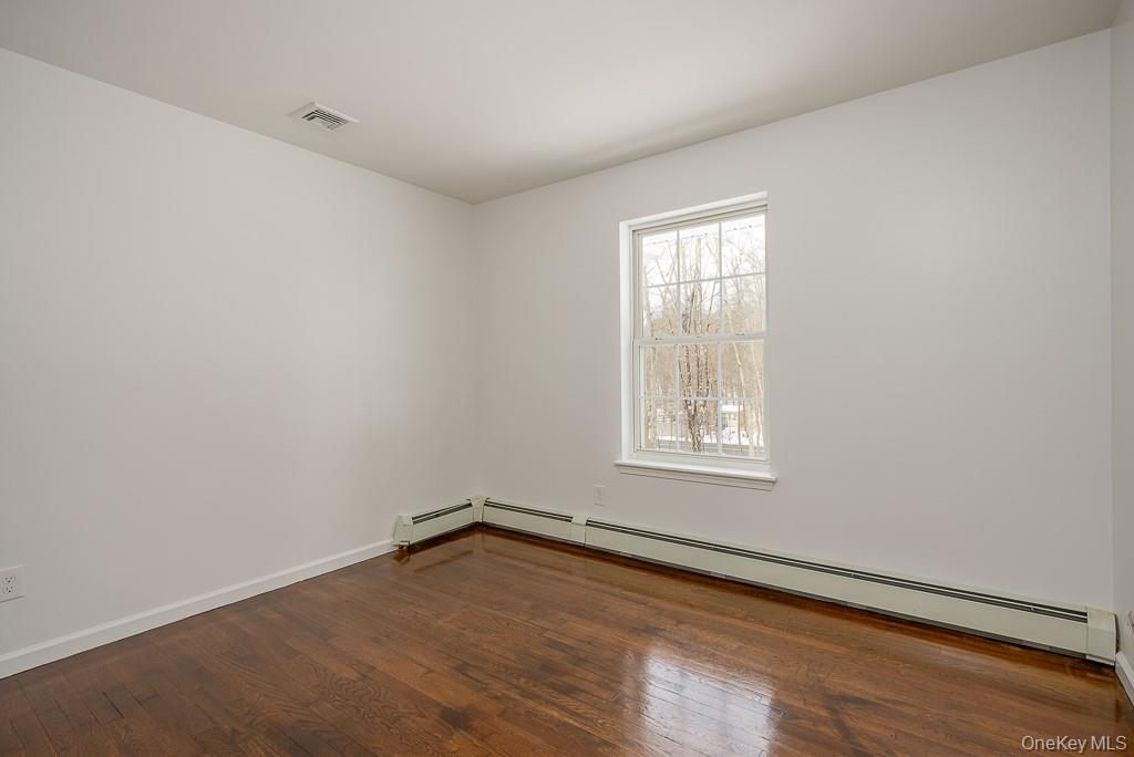 600 Twin Arch Road Rock Tavern, NY 12575 - Photo 12 of 25 Spare room with baseboard heating and dark wood-style floors