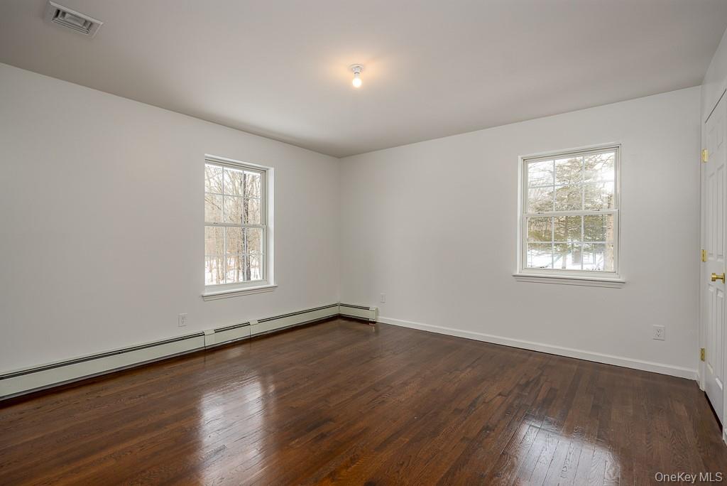 600 Twin Arch Road Rock Tavern, NY 12575 - Photo 13 of 25 Spare room featuring a baseboard radiator and dark wood finished floors