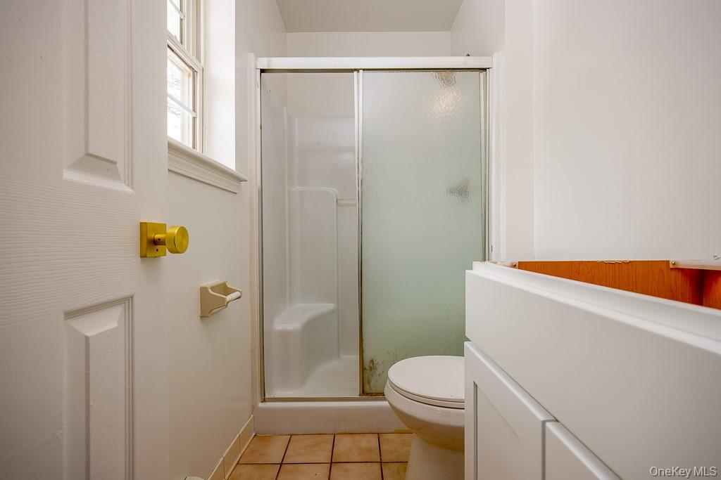 600 Twin Arch Road Rock Tavern, NY 12575 - Photo 15 of 25 Full bathroom with a stall shower, vanity, and light tile patterned floors