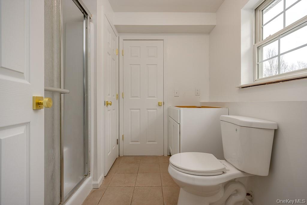 600 Twin Arch Road Rock Tavern, NY 12575 - Photo 17 of 25 Bathroom featuring a stall shower and light tile patterned flooring
