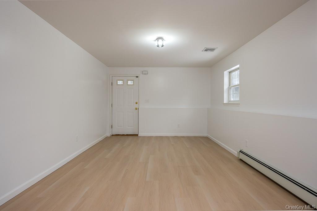 600 Twin Arch Road Rock Tavern, NY 12575 - Photo 18 of 25 Spare room with a baseboard radiator and light wood-style floors