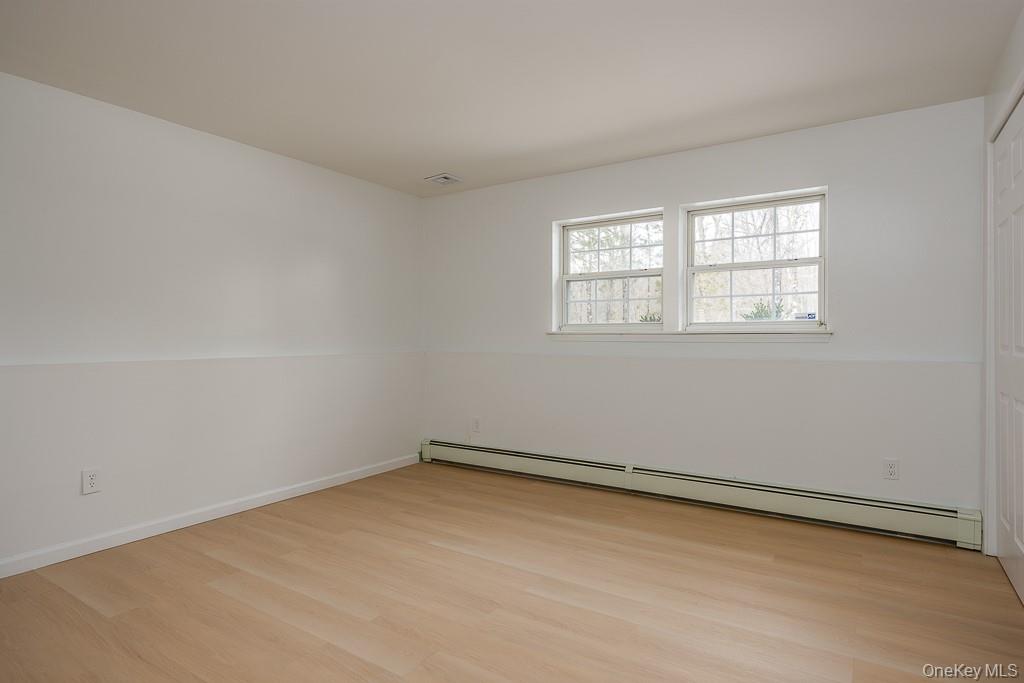 600 Twin Arch Road Rock Tavern, NY 12575 - Photo 19 of 25 Spare room featuring a baseboard heating unit and light wood-style floors