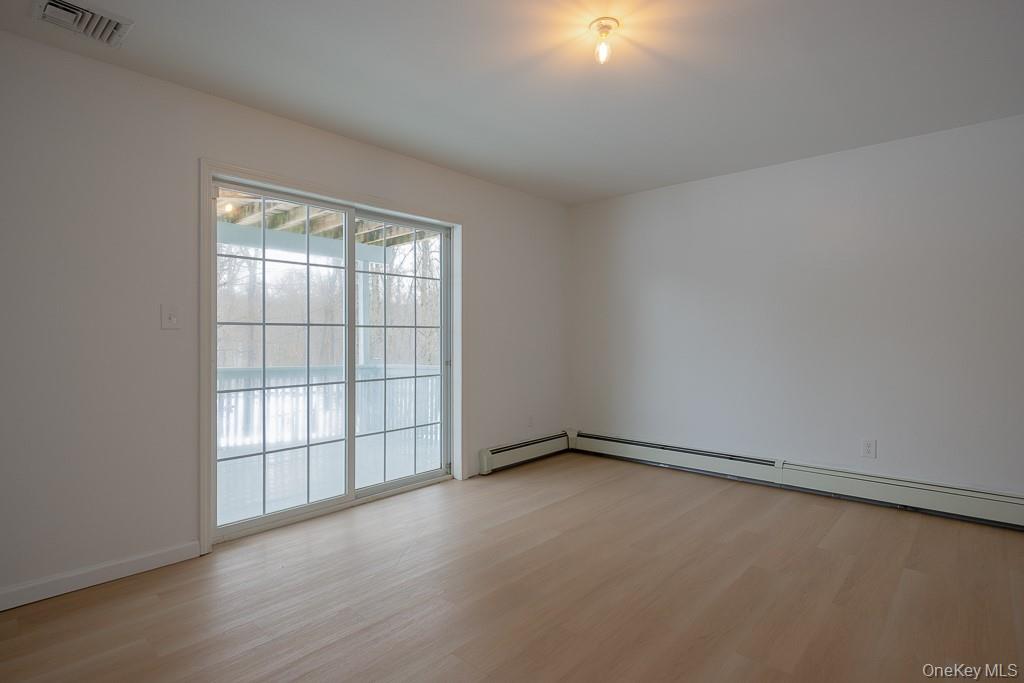 600 Twin Arch Road Rock Tavern, NY 12575 - Photo 20 of 25 Spare room with light wood-style floors and baseboard heating