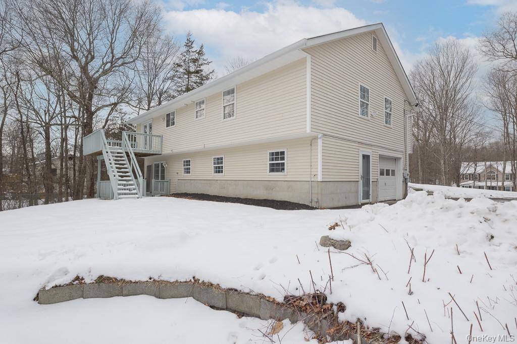 600 Twin Arch Road Rock Tavern, NY 12575 - Photo 21 of 25 Snow covered property featuring an attached garage, stairway, and a deck