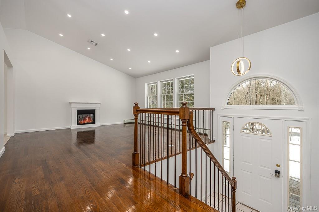 600 Twin Arch Road Rock Tavern, NY 12575 - Photo 6 of 25 Entryway with high vaulted ceiling, recessed lighting, dark wood-style flooring, and a glass covered fireplace