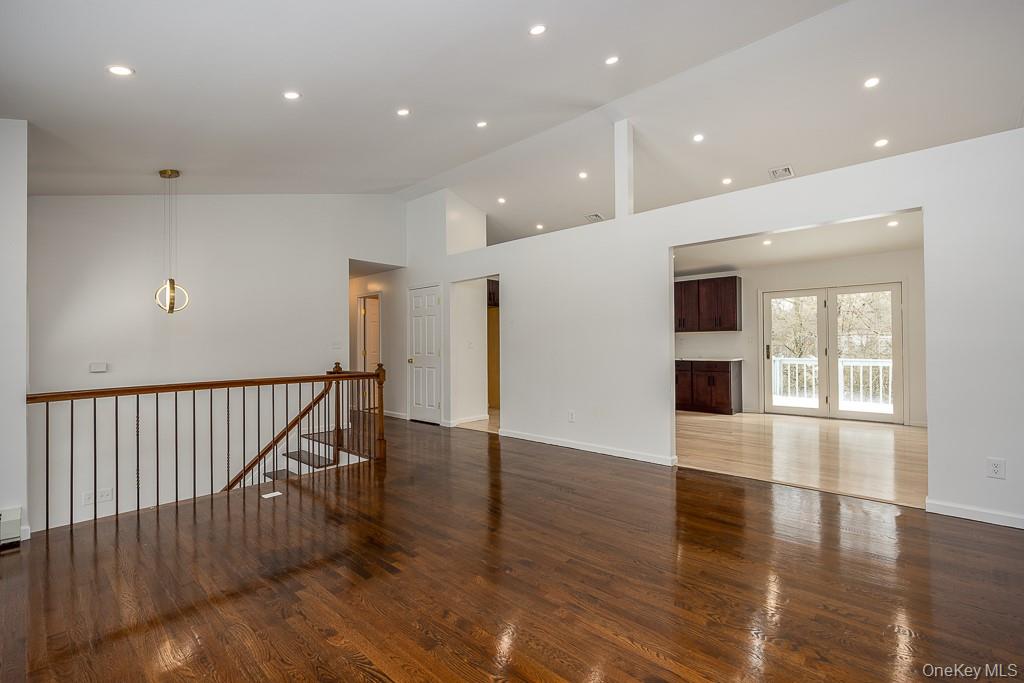 600 Twin Arch Road Rock Tavern, NY 12575 - Photo 8 of 25 Unfurnished room with high vaulted ceiling, recessed lighting, dark wood-style flooring, and french doors