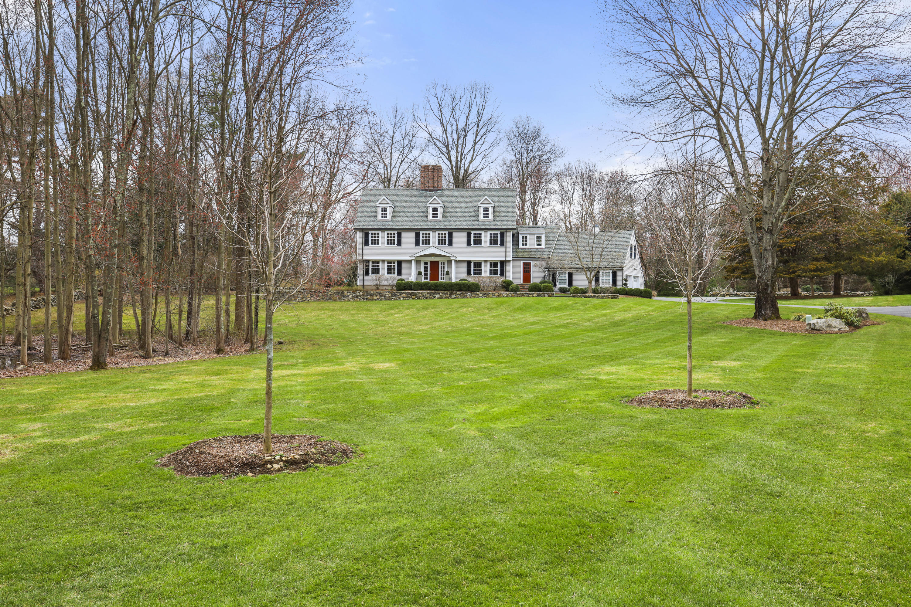 501 Brookside Road New Canaan, CT 06840 - Photo 1 of 38 a garden with trees in the background