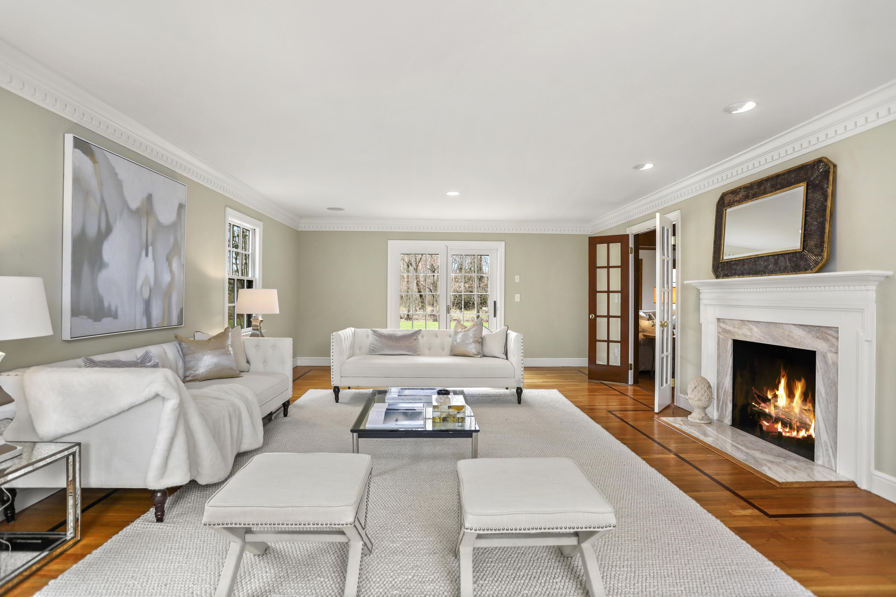 501 Brookside Road New Canaan, CT 06840 - Photo 2 of 38 a living room with furniture large window and a fireplace