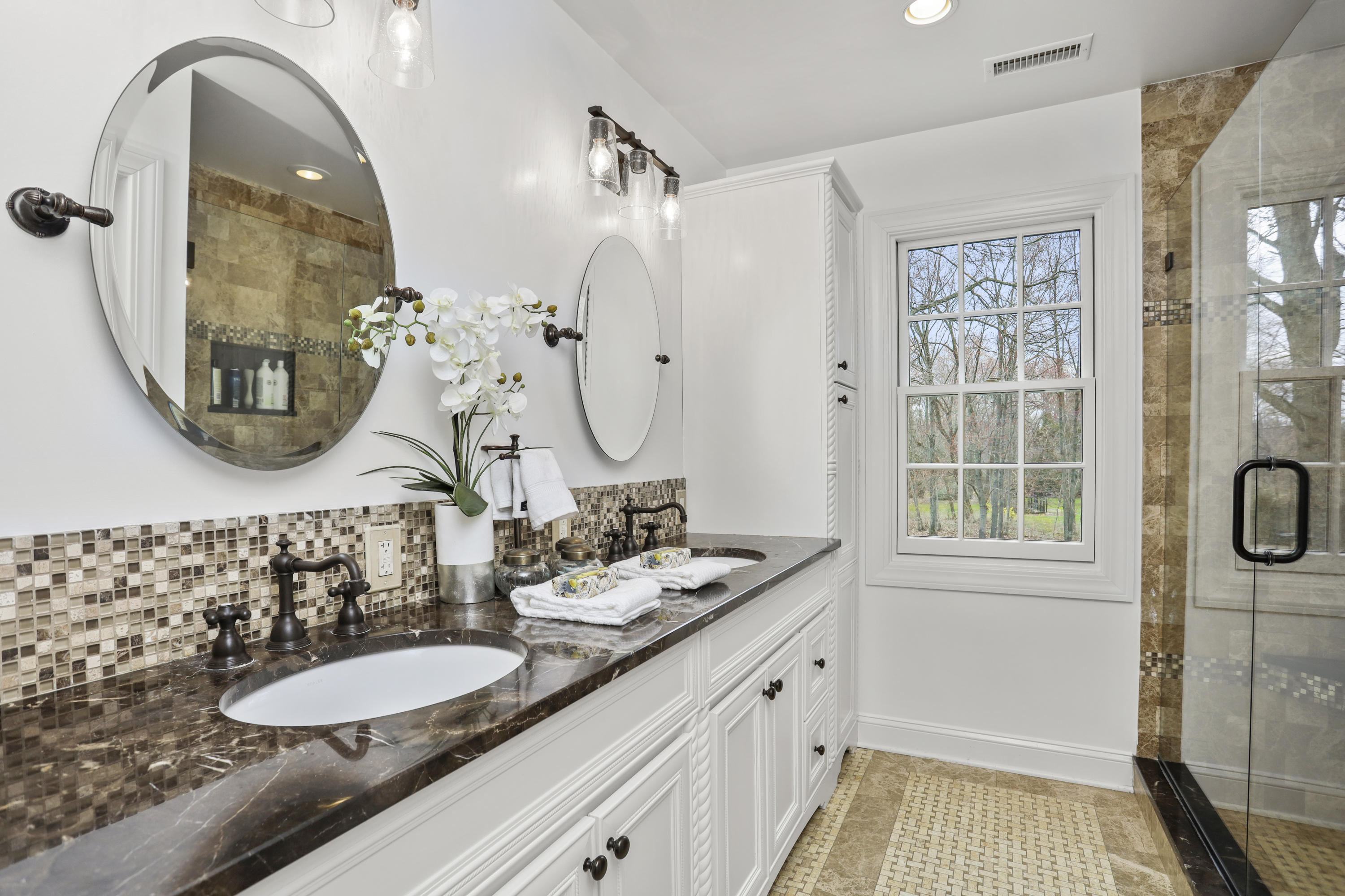 501 Brookside Road New Canaan, CT 06840 - Photo 19 of 38 a bathroom with a double vanity sink and a mirror