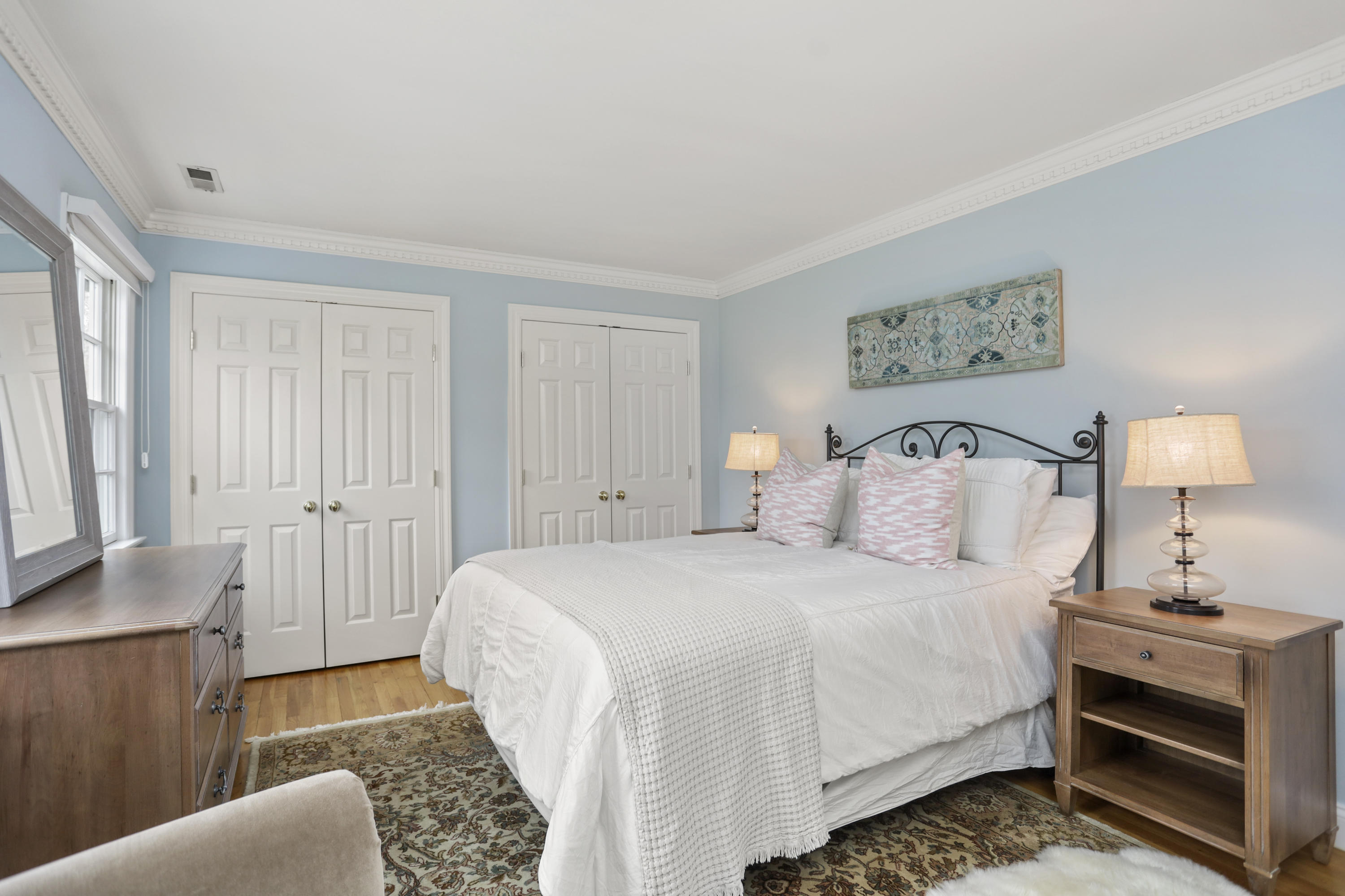 501 Brookside Road New Canaan, CT 06840 - Photo 23 of 38 a bedroom with a bed and a lamp on dresser