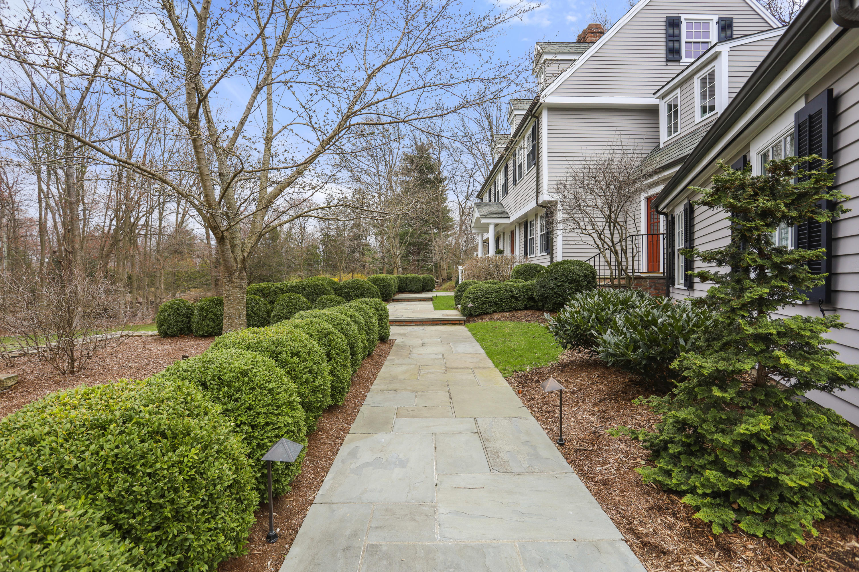 501 Brookside Road New Canaan, CT 06840 - Photo 33 of 38 a view of a pathway with house on both side