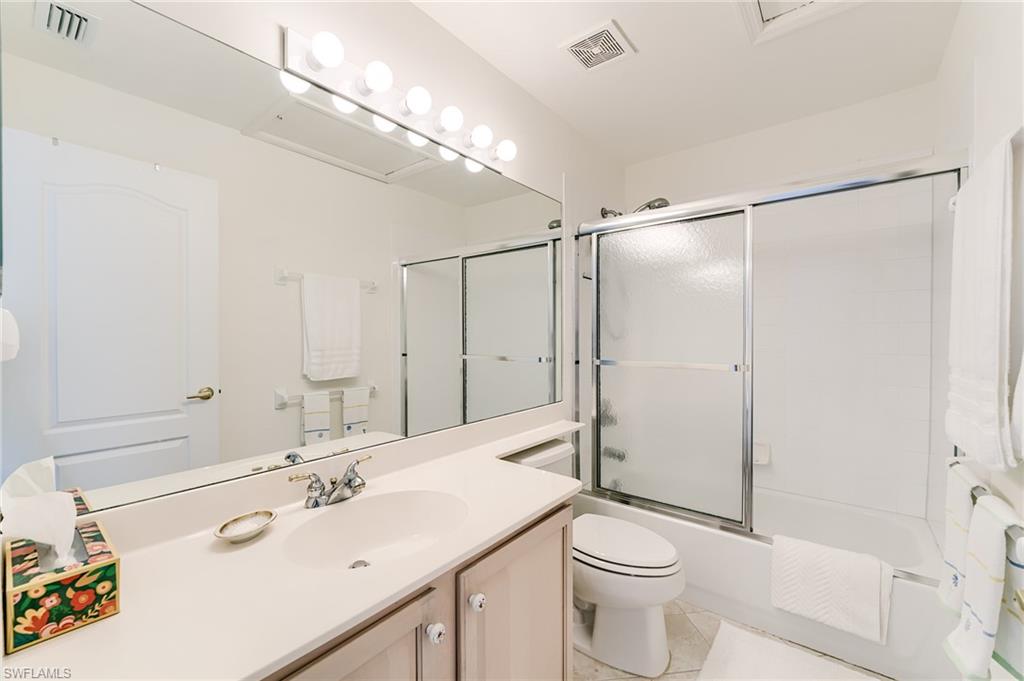 9156 Spring Run Boulevard Estero, FL 34135 - Photo 20 of 34 a bathroom with a sink a toilet and shower