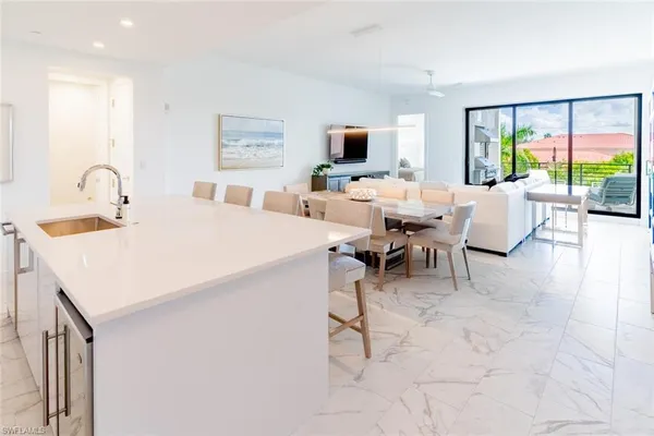 a living room with furniture a flat screen tv and a large window