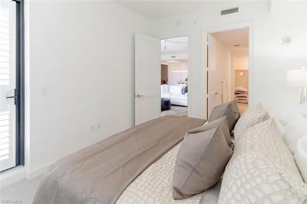 a bedroom with a bed and a mirror