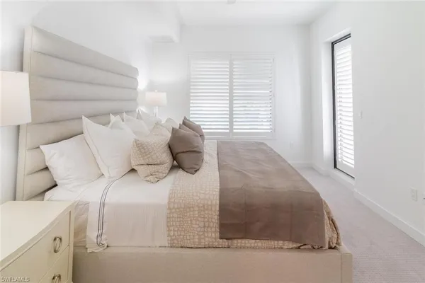 a bed sitting in a bedroom next to a window