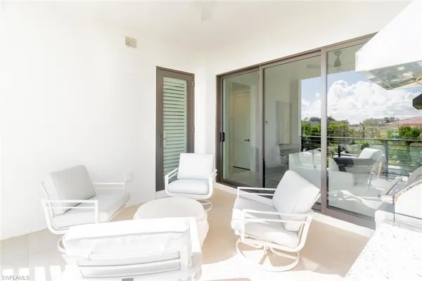 a living room with furniture a rug and white walls