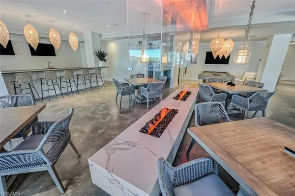 a living room with furniture and view of kitchen