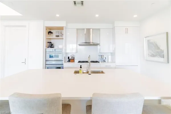 a kitchen with kitchen island cabinets and refrigerator
