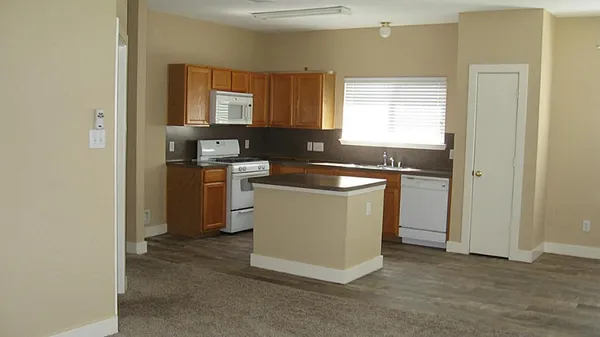 a utility room with cabinets washer and dryer