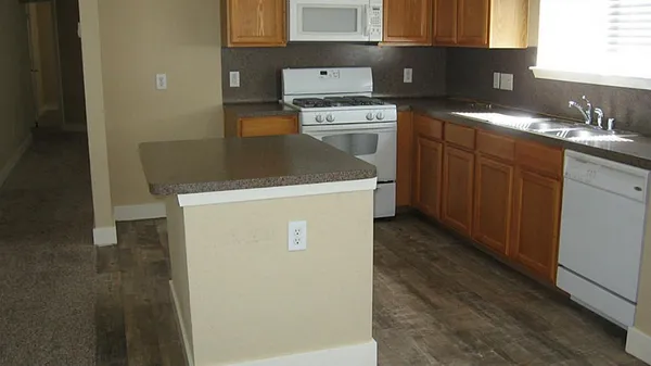 a kitchen with a stove top oven and sink