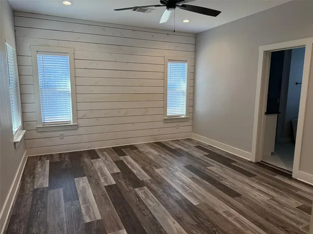 a view of a room with wooden floor