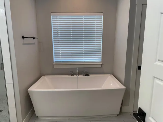 a white bath tub sitting in a bathroom