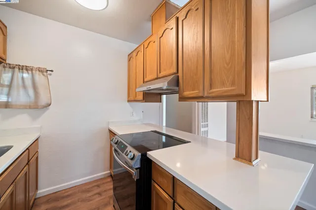a kitchen that has a sink and a stove in it