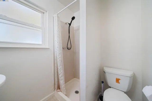 a bathroom with a toilet and shower