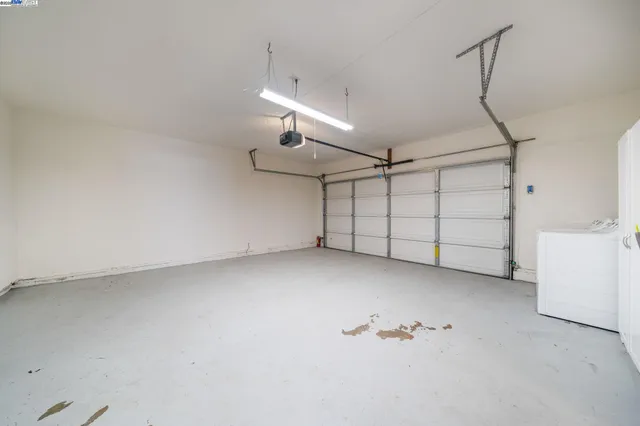 an empty room with a ceiling fan and window