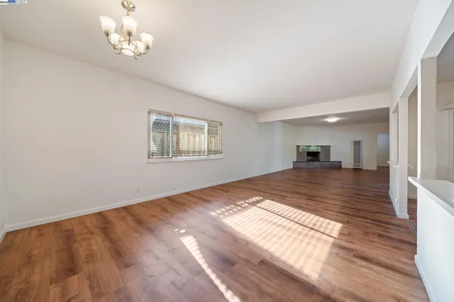 a view of a room with a window and wooden floor