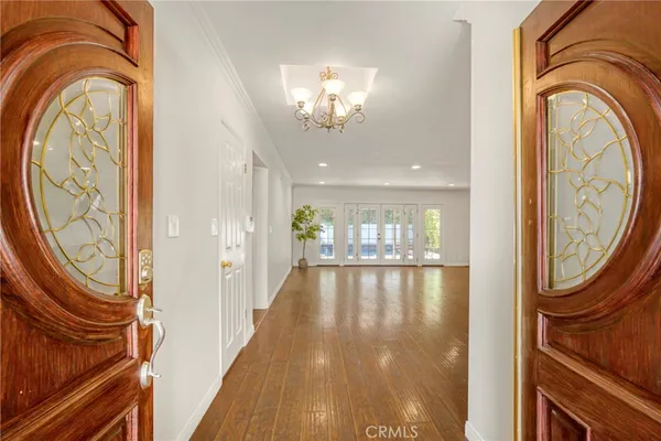 a dining room with furniture a chandelier and a large mirror
