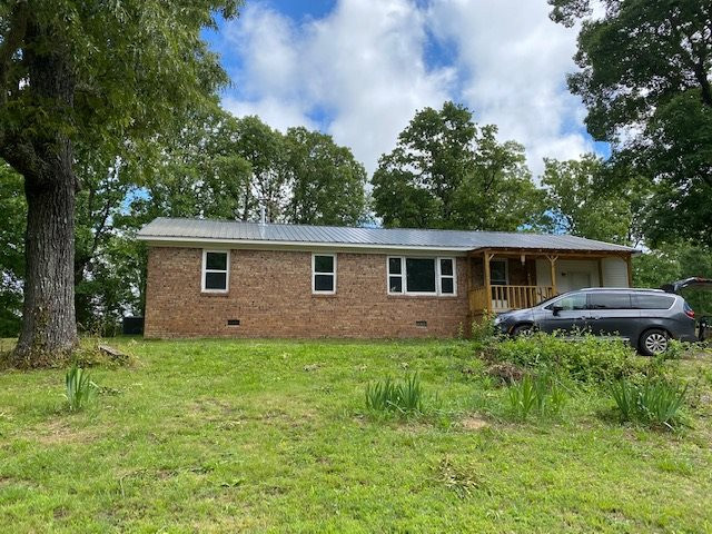 1602 Sweet Lips Road Finger, TN 38334 - Photo 1 of 1 a front view of a house with a garden