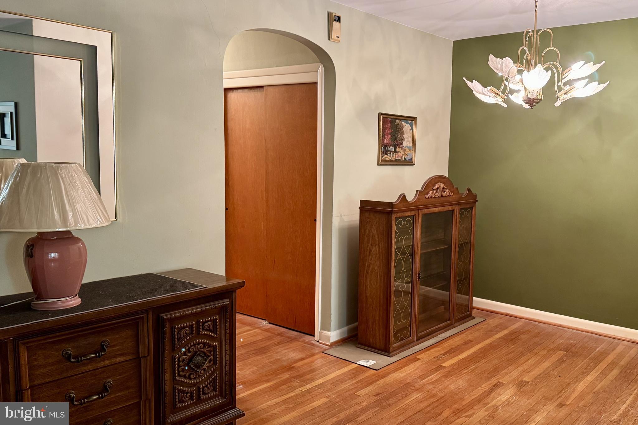 2317 Emerson Street Philadelphia, PA 19152 - Photo 4 of 18 a view of a livingroom with a chandelier and wooden floor