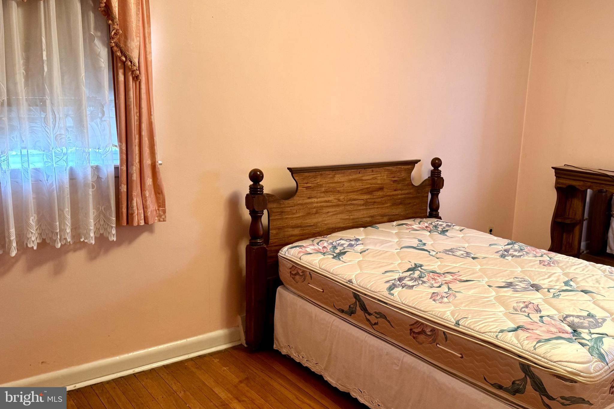 2317 Emerson Street Philadelphia, PA 19152 - Photo 9 of 18 a bed sitting in a bedroom next to a window