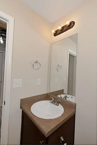 a bathroom with a sink and a mirror