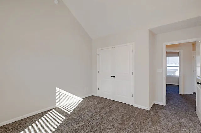 a view of an empty room and wooden floor