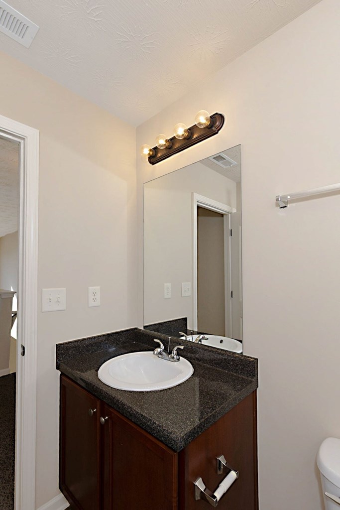18 Memorial Drive Fort Mitchell, AL 36856 - Photo 22 of 33 a bathroom with a granite countertop sink and a mirror