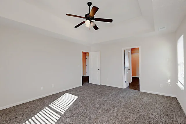 a view of room with a ceiling fan
