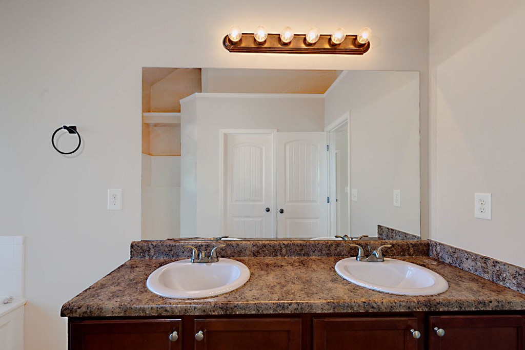 18 Memorial Drive Fort Mitchell, AL 36856 - Photo 26 of 33 a bathroom with a granite countertop sink and a mirror