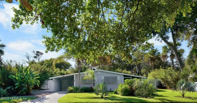 a front view of house with a garden