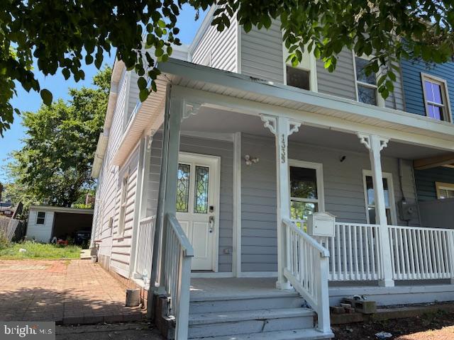 a view of a house with a small yard and wooden floor and fence