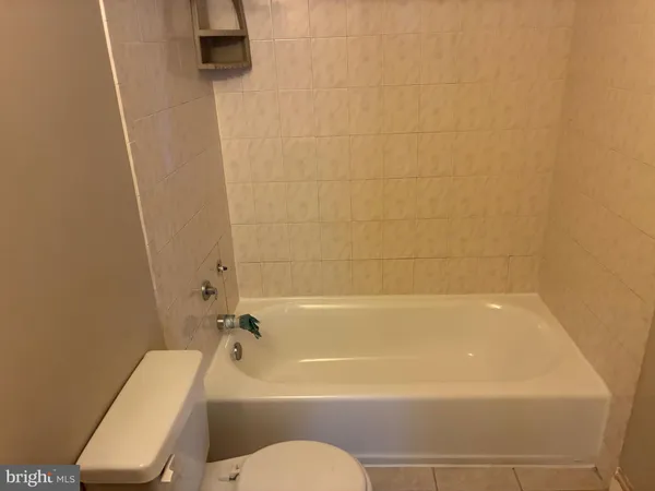 a bathroom with a toilet and a bath tub